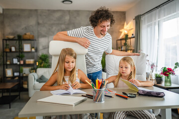 Single father help to his daughters to do homework