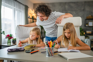 Single father help to his daughters to do homework