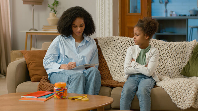 African American psychologist home reception patient mental psychology health woman little girl child talk conversation dialogue professional specialist write complaints trust consultation communicate