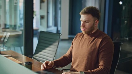 Tired worker closing laptop feeling neck pain at modern workplace closeup. 