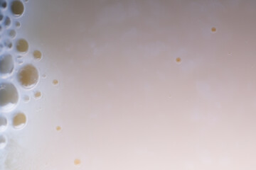 The vinegar and milk react to form curds.