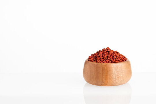 Organic red annatto seeds in the bowl - Bixa Orellana