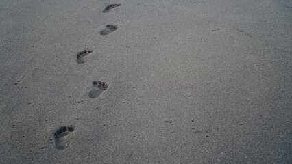 Human footprints on the beach sand. Focus selected