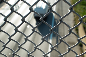 Fototapeta premium semi truck viewed through fencing on a bridge