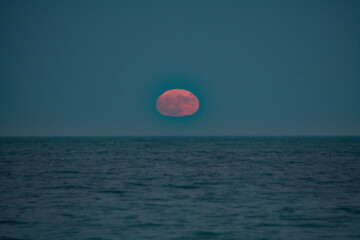Full moon rises over the Atlantic ocean