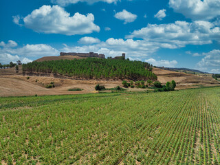 Aerial view of Huerta de la Obispalia in La Mancha Spain, hilltop medieval fortification with pentagonal bastion gun platforms at both ends