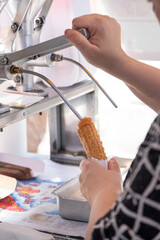 Woman stuffing churros covered with sugar and cinnamon with dulce de leche_2.