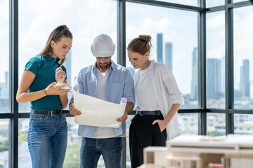 Group of architect engineer looking at project plan while brainstorming idea about building structure. Manager team discuss about building construction while standing near with city view. Tracery.