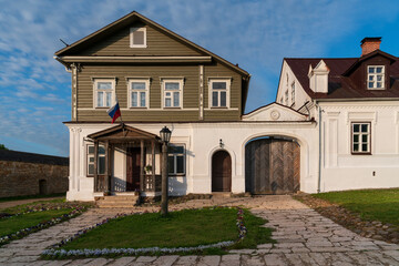 View of historical merchant buildings of estates on the main street of Izborsk Pechorskaya Street on a summer sunny day, Izborsk, Pskov region, Russia