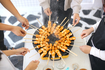 Group Of Friends Making Barbecue Grilling Over A Hot Fire