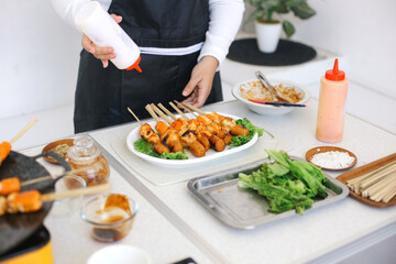 Woman Making Satay From Dumplings at The Kitchen