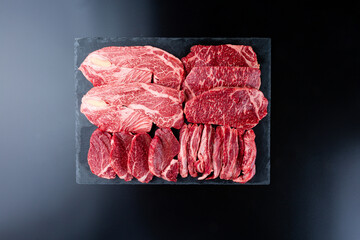 Sliced ​​beef on a black background