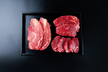 Sliced ​​beef on a black background