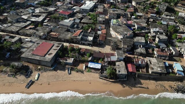 Aerial view of Moh&eacute;li or Mwali, part of the Union of the Comoros, drone fly above fisherman village with car driving on narrowed road