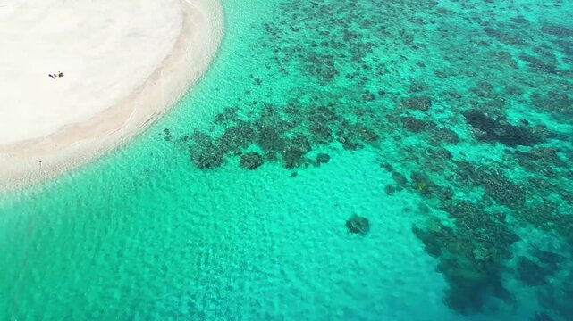 aerial top down blue pristine clear ocean sea water with coral reef and white sand beach in tropical paradise island Moh&eacute;li or Mwali, part of the Union of the Comoros