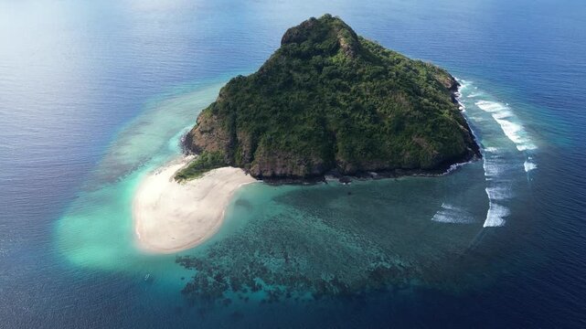 Aerial top down of little islet with pristine clear blue ocean water and coral reef white sand tropical beach , drone fly above Moh&eacute;li or Mwali, part of the Union of the Comoros