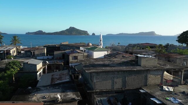 drone fly above small village in Moh&eacute;li or Mwali, part of the Union of the Comoros aerial close up of white old Fomboni mosque Arab heritage with other archipelago islands view at distance
