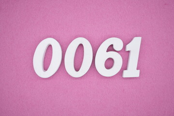 The numbers are made of white painted wood. Laying on the floor was pink paper.