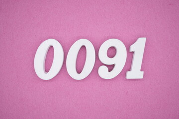 The numbers are made of white painted wood. Laying on the floor was pink paper.