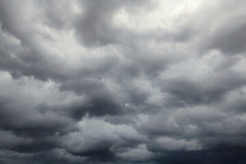 Dark dramatic sky with black stormy clouds before rain or snow as abstract background, extreme weather