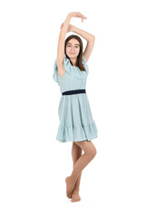 Young beautiful girl in a dress with polka dots on a white background.