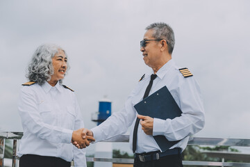 Professional pilot woman in uniform has teamwork meeting for success flight in aviation business. Young female captain instructor sitting in office and working or training commercial airline crew.