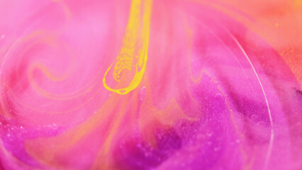 Shimmer ink. Glitter liquid. Defocused pink yellow color gleaming particles spill brilliance shiny...