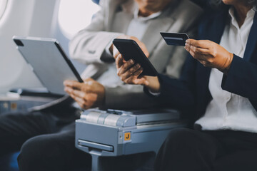 .A mature couple enjoys a plane ride sitting near the window. They looked out into the sky. Immerse yourself in the scenery and excitement of the journey. To create precious memories together