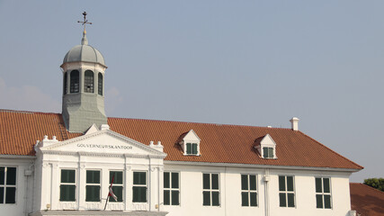 A serene view of the Fatahillah Museum, housed in a colonial-era building with a classic Dutch...