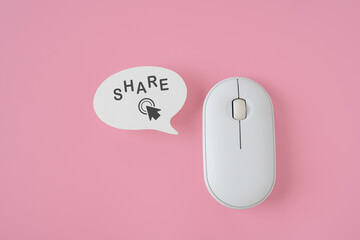 share word and click icon on real speech bubble paper cut , computer wireless mouse  on pink...