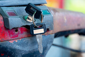 Close up of a lock on a bicycle with a key in it. Vintag of Motorcycle with blurred image.