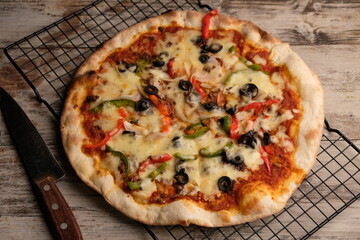 Pizza is a savory dish from Italy, a type of round, flat dough, which is baked in the oven and usually covered in tomato sauce and cheese with other additional food ingredients.