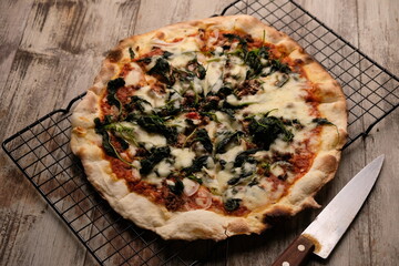 Pizza is a savory dish from Italy, a type of round, flat dough, which is baked in the oven and usually covered in tomato sauce and cheese with other additional food ingredients.