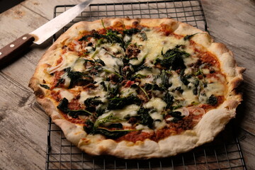 Pizza is a savory dish from Italy, a type of round, flat dough, which is baked in the oven and usually covered in tomato sauce and cheese with other additional food ingredients.