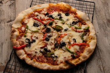 Pizza is a savory dish from Italy, a type of round, flat dough, which is baked in the oven and usually covered in tomato sauce and cheese with other additional food ingredients.