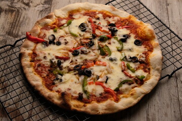 Pizza is a savory dish from Italy, a type of round, flat dough, which is baked in the oven and usually covered in tomato sauce and cheese with other additional food ingredients.