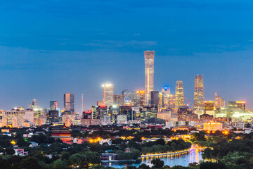 Obraz premium High angle night view of Guomao CBD and Bell and Drum Tower in Beijing, China