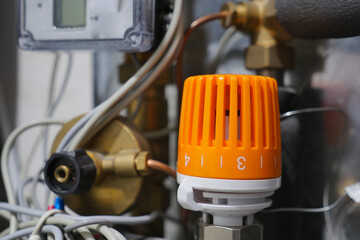 Detailed CloseUp of the Heating System Control Valve Featuring an Orange Dial Indicator