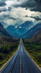 Naklejka premium A long empty road in the middle of a mountain range