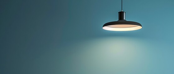 A lighted lamp is shining on a blue wall