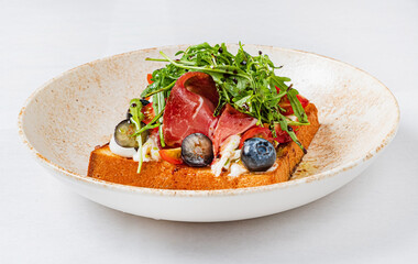 toast with cheese, ham and blueberries