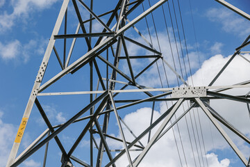 Fototapeta premium Metal structure steel frame of electricity transmission tower, Electricity pylon engineering and design.