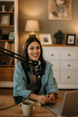 Smiling content creator recording an internet podcast for her social media channel