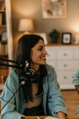 A female podcaster exchanging ideas in a comfortable living room