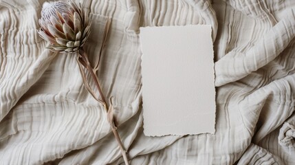 A piece of paper sits on top of a bed