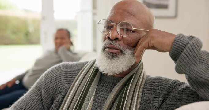 Elderly, couple and angry on sofa with conflict, argument or marriage problems in living room of home. Senior, black people and frustrated for fighting, breakup or divorce with communication on couch
