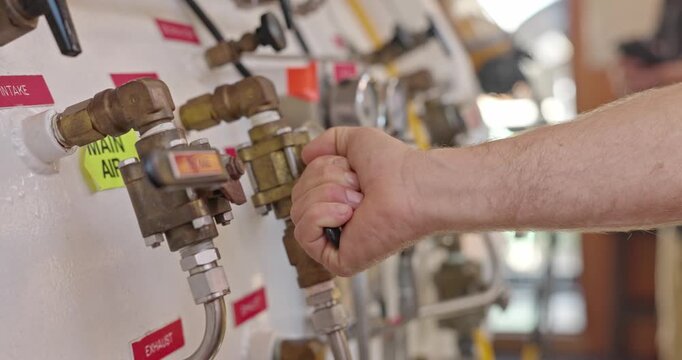Man operating valves on hyperbaric chamber close up