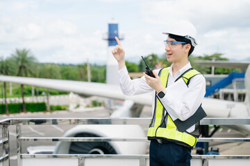 Male aviation engineer in safety gear inspecting an airplane engine, embodying professionalism