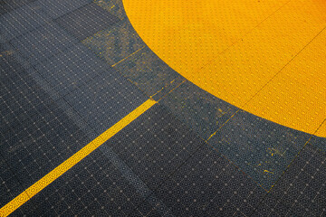 Non slip plastic surface of an outdoor basketball court