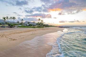 Golden Waves Embrace Sandy Beach Shoreline